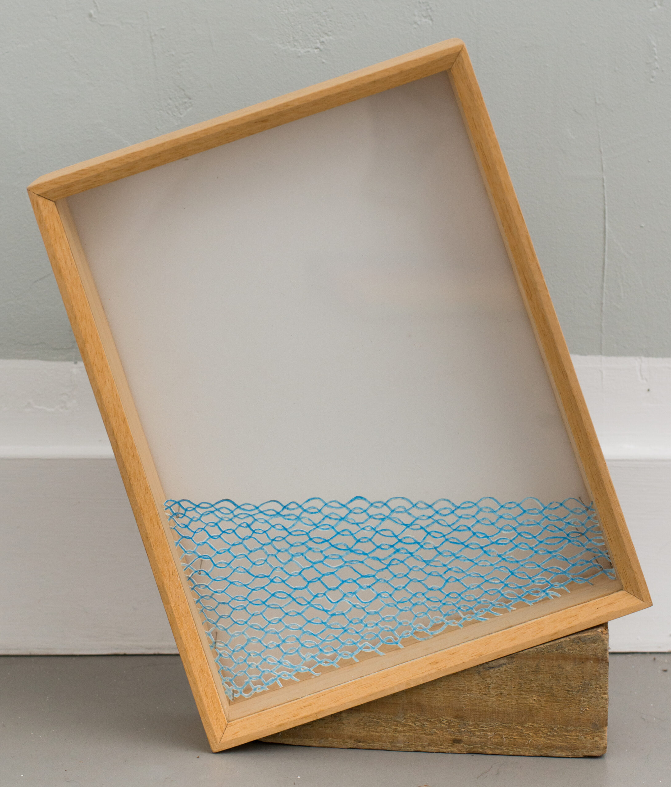 Benoît Felix, Toujours le bon niveau (un flet d’eau), 2025, Cut-out drawing, color pencil on Tyvek, 4 pins, box with glass, wood, 30 x 40 cm