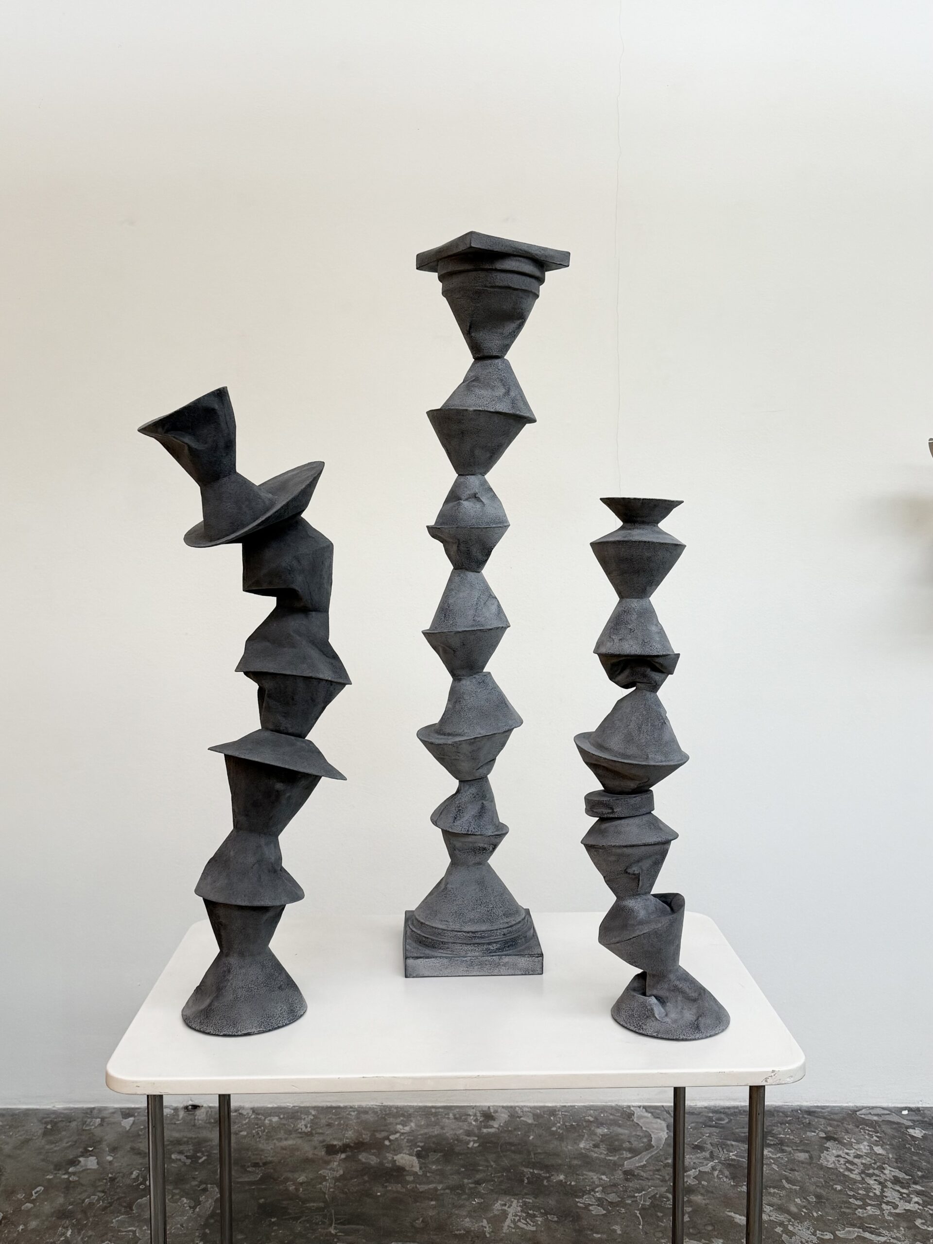 Johan de Wit, 2024, group of columns, highest one, 110 cm, paper, resins, iron powder, pigments